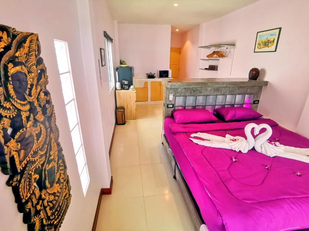 Postel nebo postele na pokoji v ubytování Mango Tree Villa