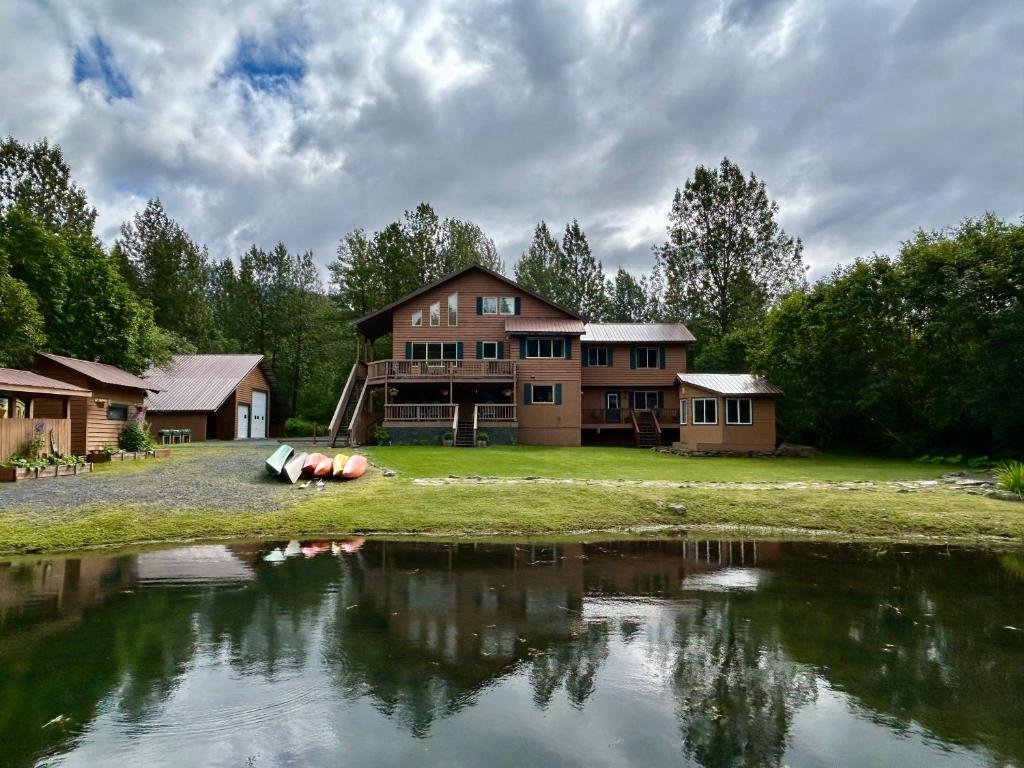 a large house next to a body of water at Bear Lake Lodgings B&B, Inc in Seward