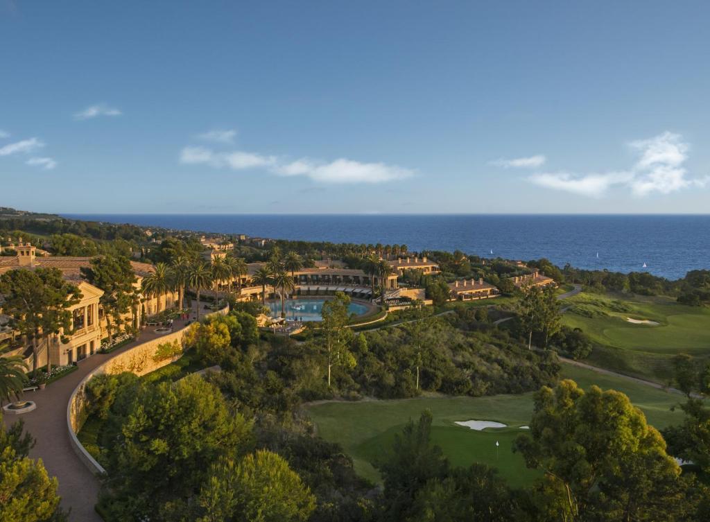an aerial view of a resort with the ocean in the background at Resort at Pelican Hill in Newport Beach