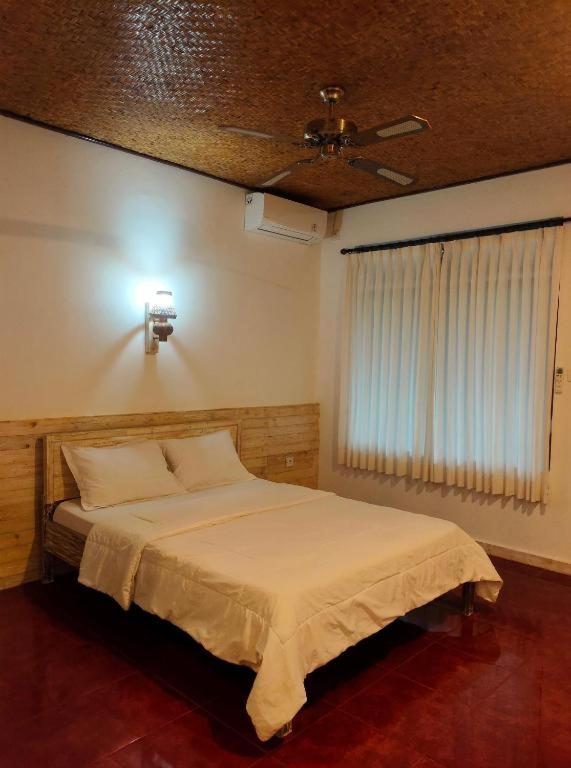 Postel nebo postele na pokoji v ubytování Candra Asri Bungalow