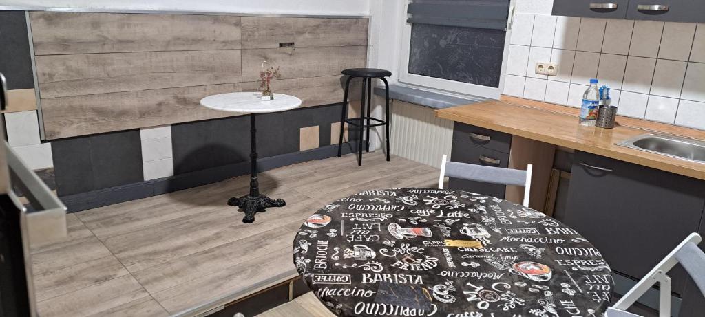 uma pequena cozinha com uma mesa e um lavatório em Pension Winter Obergeschoss em Senftenberg