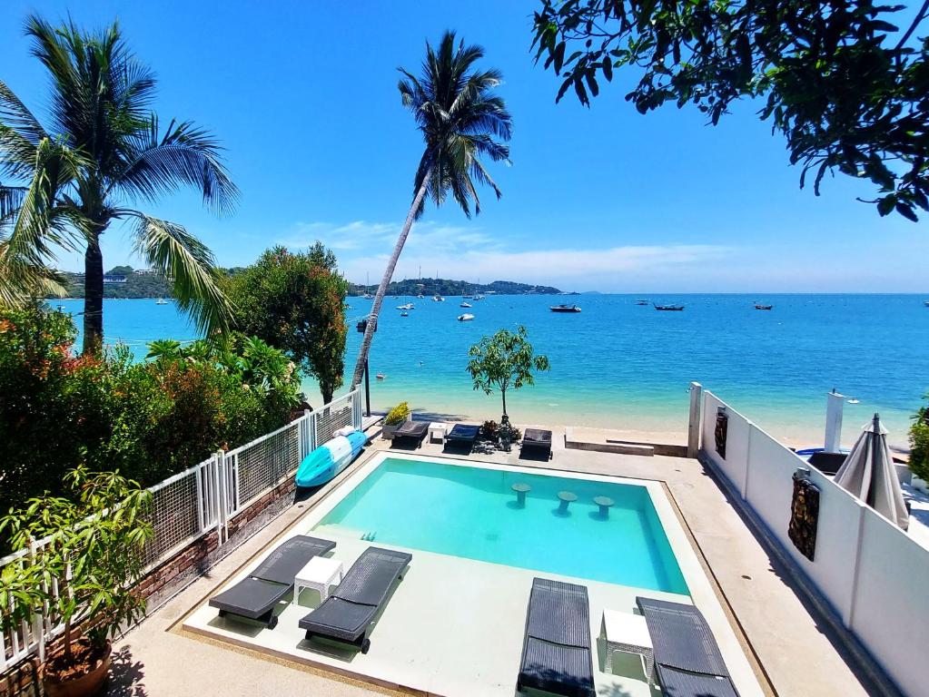 a swimming pool with a view of the beach at Mango Tree Villa in Panwa Beach