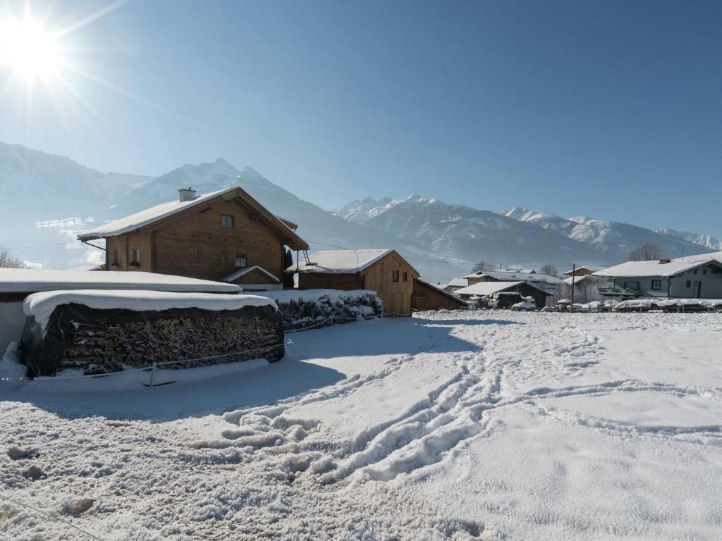 a snow covered yard with a car parked in the driveway at Chalet in Piesendorf near Ski Slopes in Piesendorf