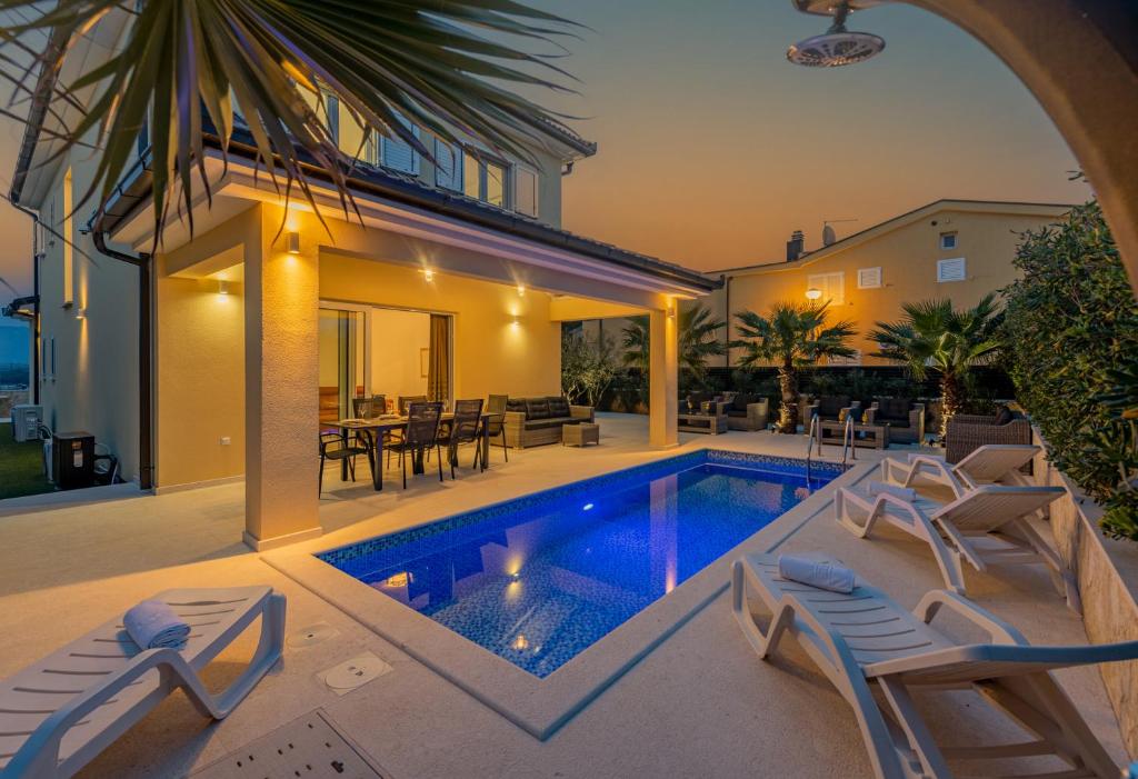 a villa with a swimming pool and a house at Luxury Villa Agape Ellita in Vir