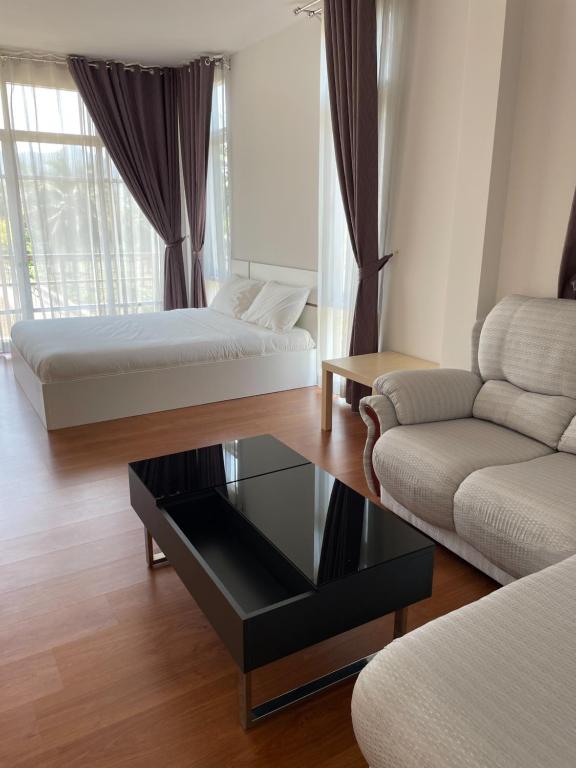 a living room with two beds and a coffee table at San Peak Villa in Sam Roi Yot