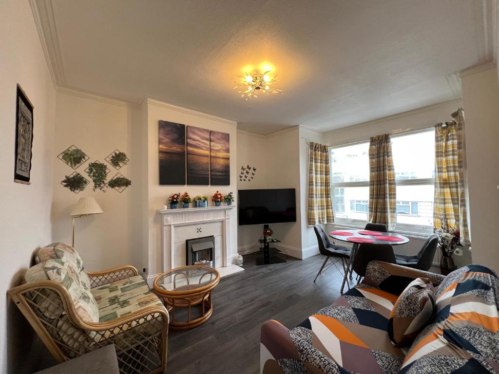 a living room with a couch and a fireplace at **Dream Home** Near Seaside (Southend on Sea) in Southend-on-Sea
