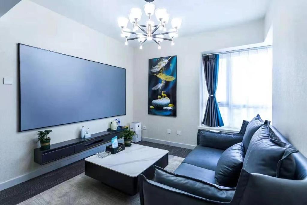TV a/nebo společenská místnost v ubytování Yise Serviced Apartment -Beijing CCTV Shop