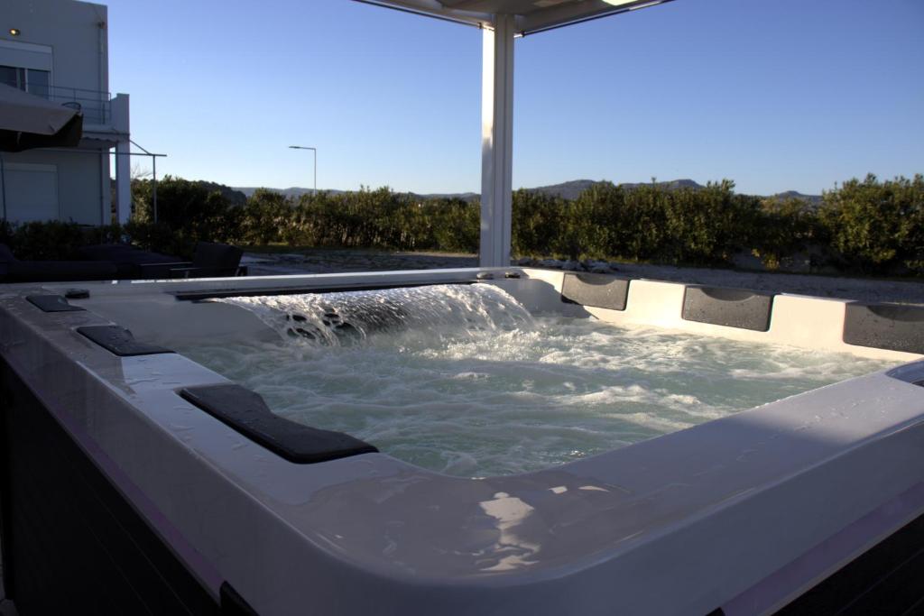 a hot tub with a water fountain in it at S-EVA RESORT in Kolymbia