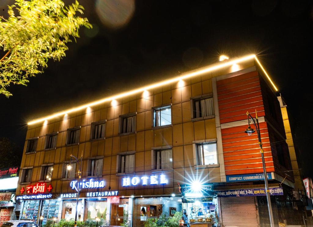 a hotel with lights on the side of a building at Hotel Krishna by KeyMagics in Jaipur