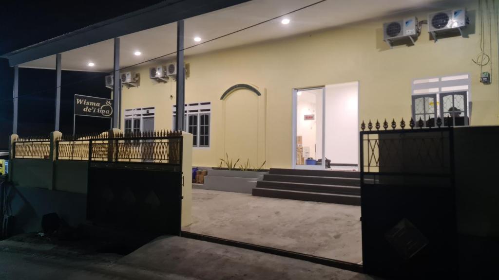 a view of a building with a gate in front at Wisma Delima in Luwuk