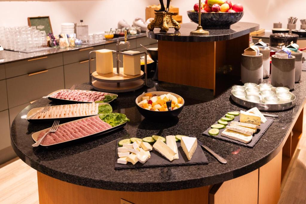a table with different types of food on it at Milling Hotel Ansgar in Odense