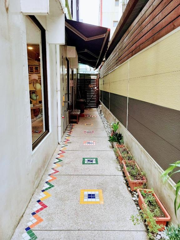 a sidewalk with colorful tiles on the side of a building at Mixa Hostel in Hualien City