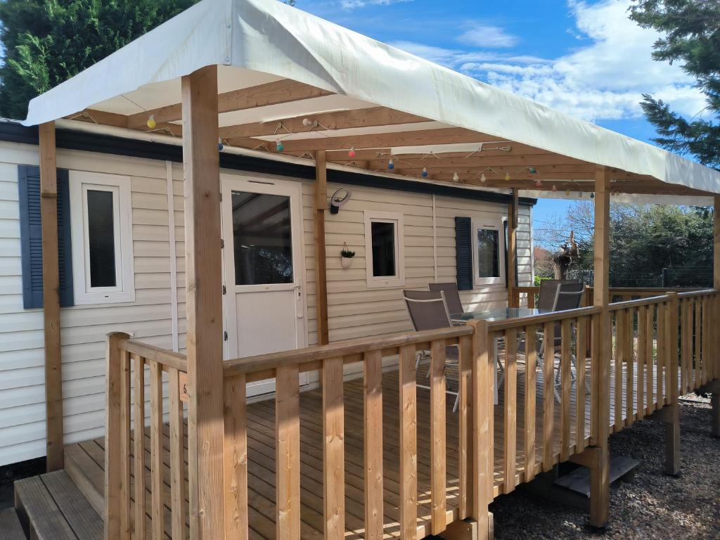 a cabin with awning on a deck at Mobil-Home en camping**** in Vic-la-Gardiole