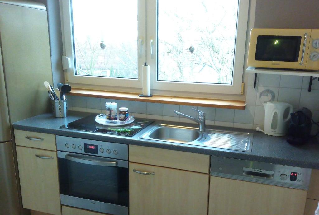 a kitchen with a sink and a microwave at Gemütliche Dachgeschosswohnung in Melle