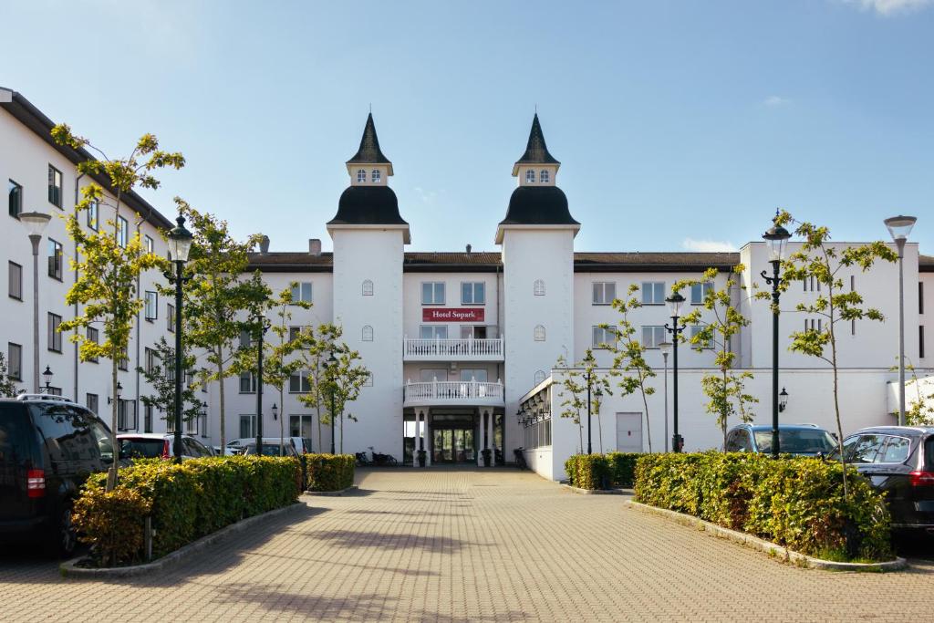 un gran edificio blanco con dos torres en la parte superior en Milling Hotel Søpark, en Maribo