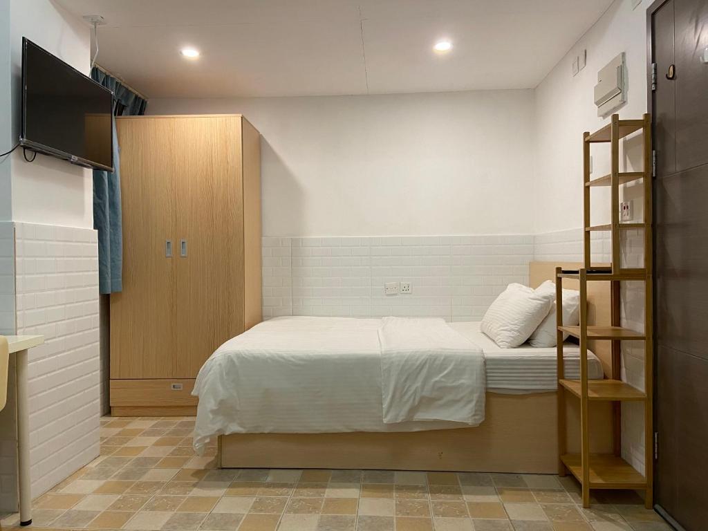 香港的住宿－凱富賓館，一间小卧室,配有一张床和电视