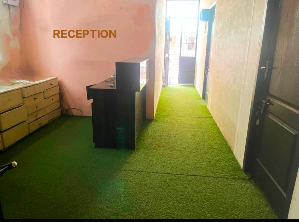 a hallway with a green floor in a room at Meera stays in Coimbatore