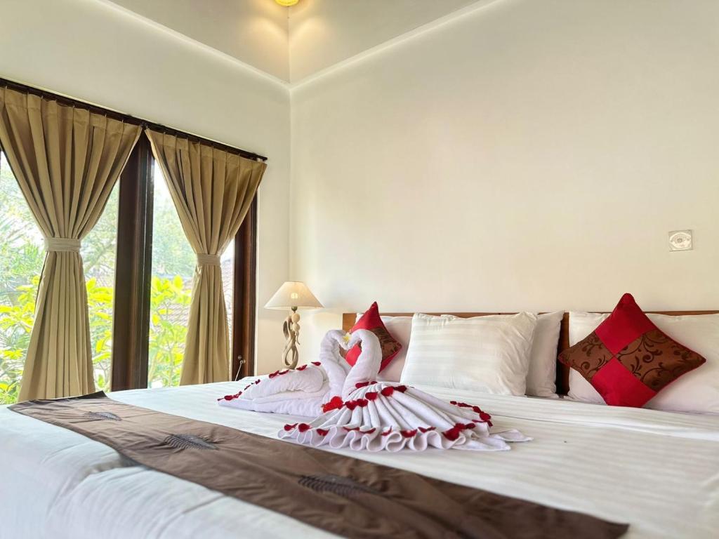 Postel nebo postele na pokoji v ubytování Bupon House Anggrek Room