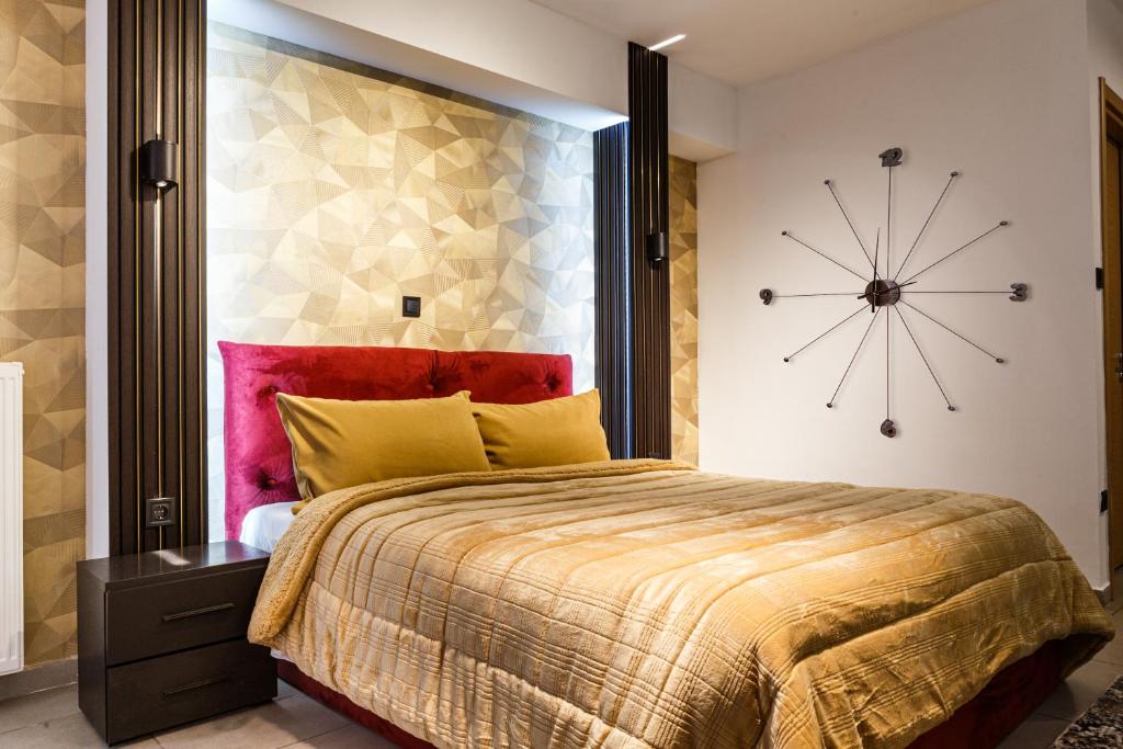 a bedroom with a large bed with a clock on the wall at Limani Comfort Rooms in Thessaloniki