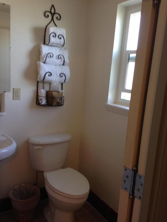 a bathroom with a toilet and a window at Rugged Country Lodge in Pendleton