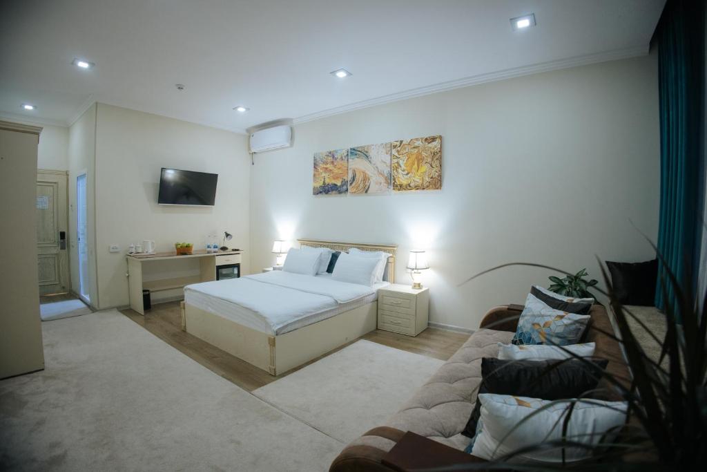 a bedroom with a bed and a couch at Like INN Hotel in Samarkand