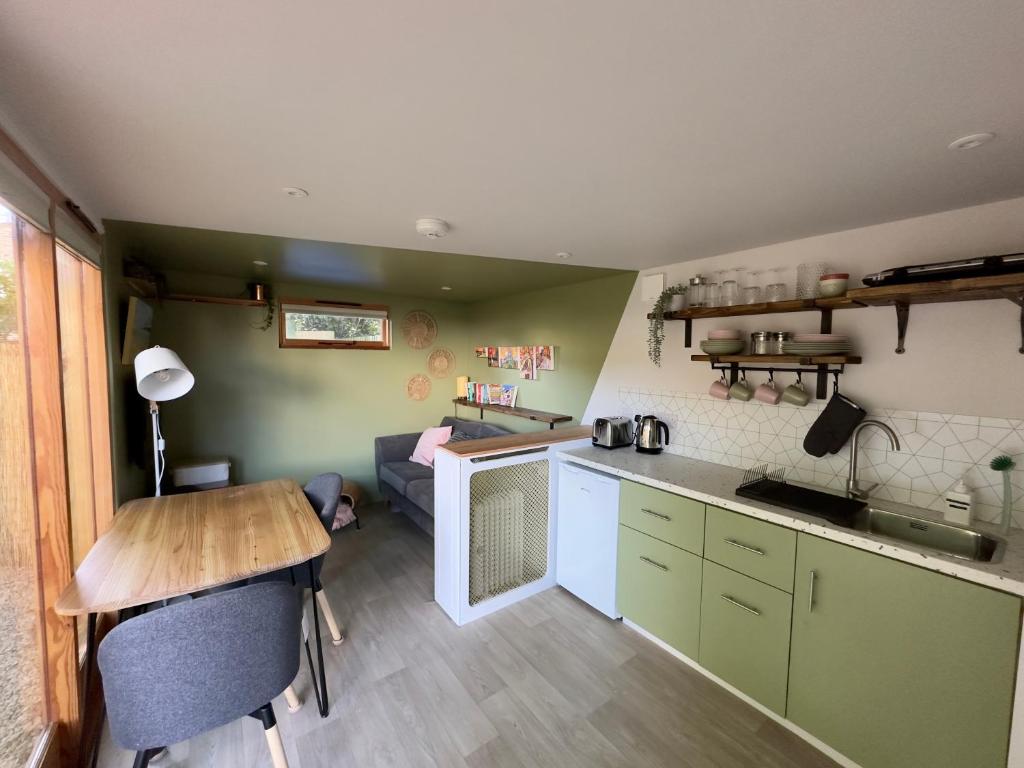 a small kitchen with a table and a counter top at The Snug: Dorset hideaway in Blandford Forum