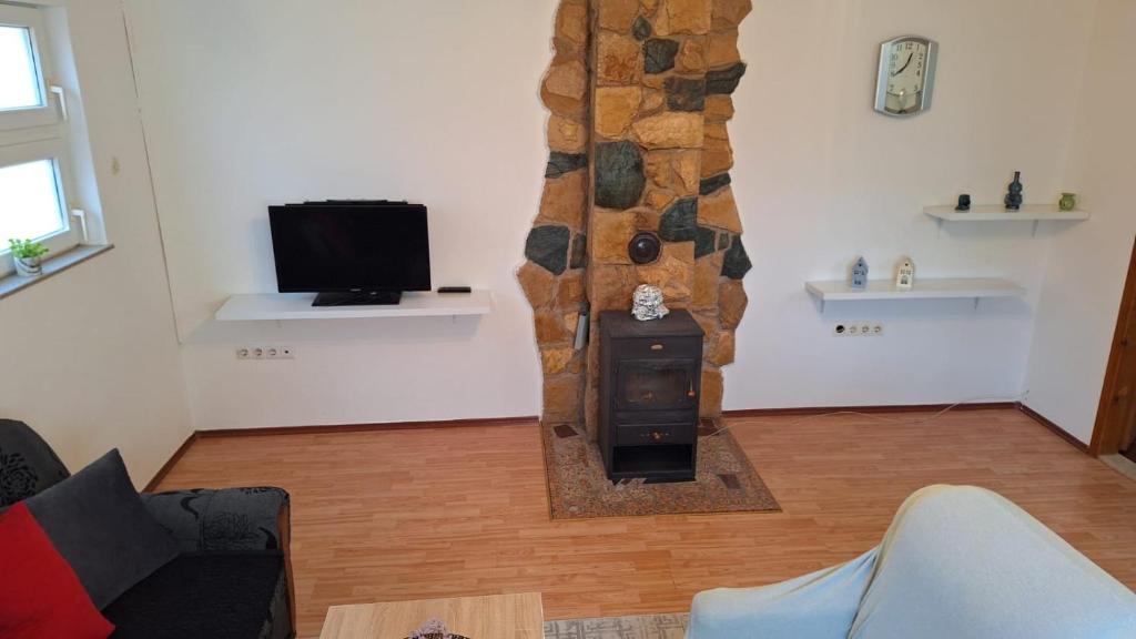 a living room with a wood stove in a room at Apartman Porfido in Mostar