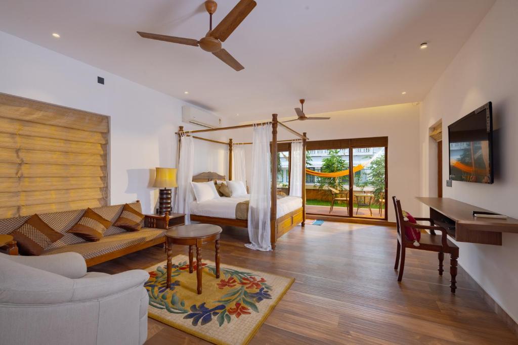 a living room with a bed and a couch at The Isle By Area 707 in Alwaye