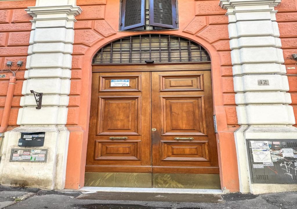 a large wooden door in a building at Giuliana Apartment in Rome