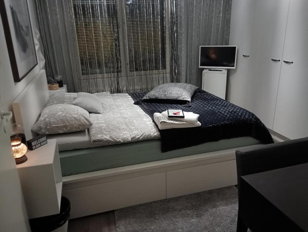 a bedroom with a bed with pillows and a window at Private Room next to Helsinki-Vantaa Airport in Vantaa