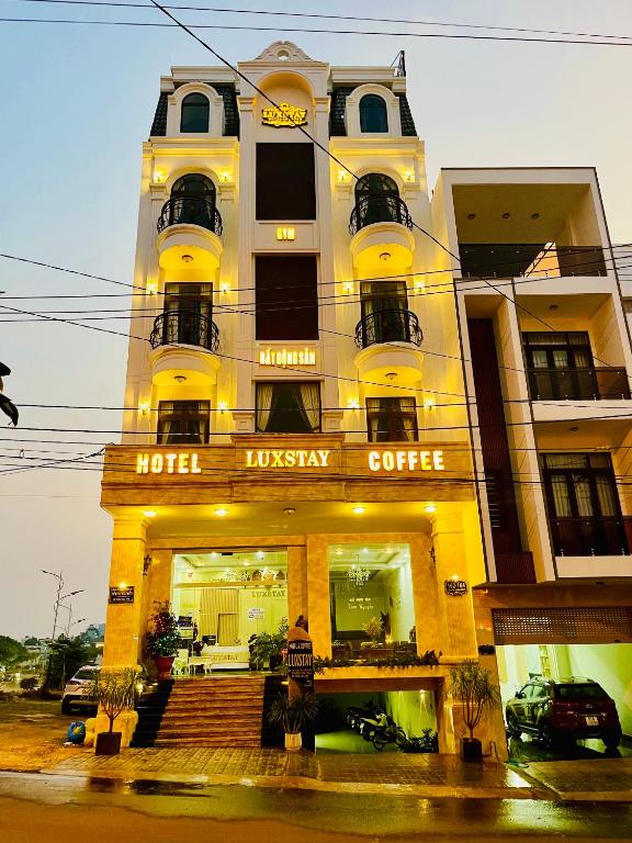 a building with a hotel industry coffee on a street at Hotel Luxstay in Pleiku