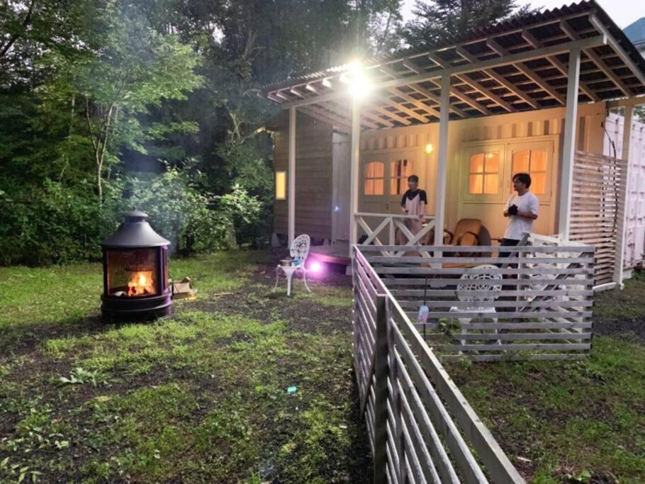 a fireplace in a yard next to a house at Kitakaruizawa Morino Bessou NO8 in Tsumagoi