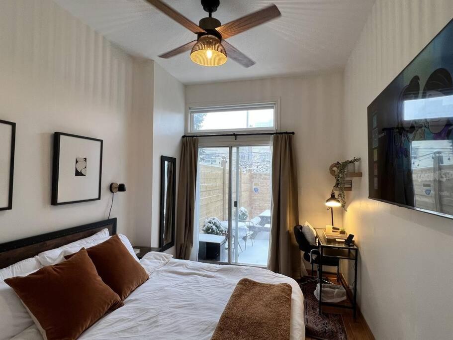 a bedroom with a bed and a ceiling fan at 3 Bedroom Victorian with Deck and Parking in Toronto