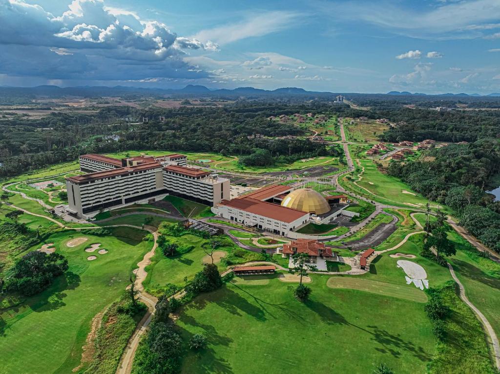 an aerial view of a building on a green field at Grand Hotel Djibloho in Djibloho