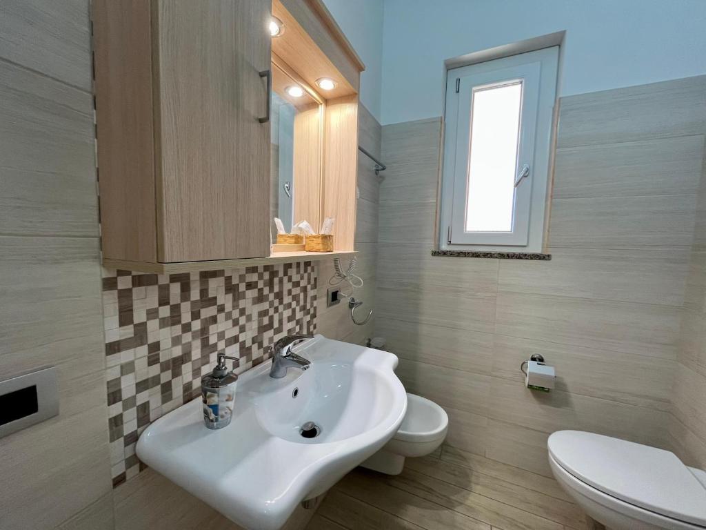 a bathroom with a sink and a toilet at B&B Galatea in Santa Domenica