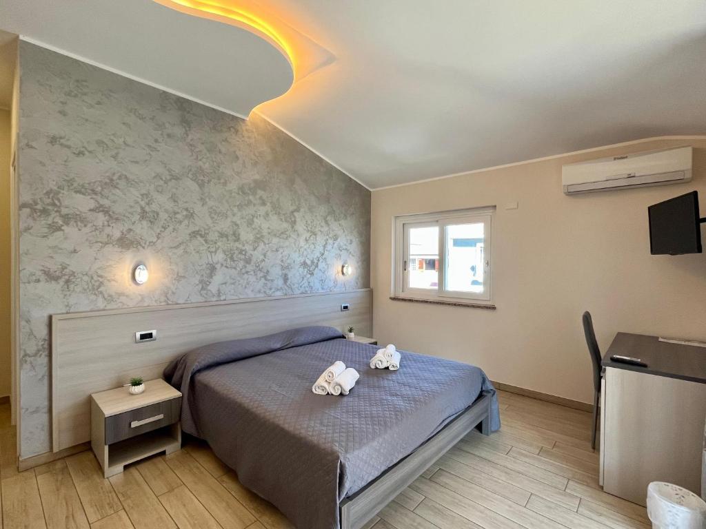 a bedroom with a bed with two teddy bears on it at B&B Galatea in Santa Domenica