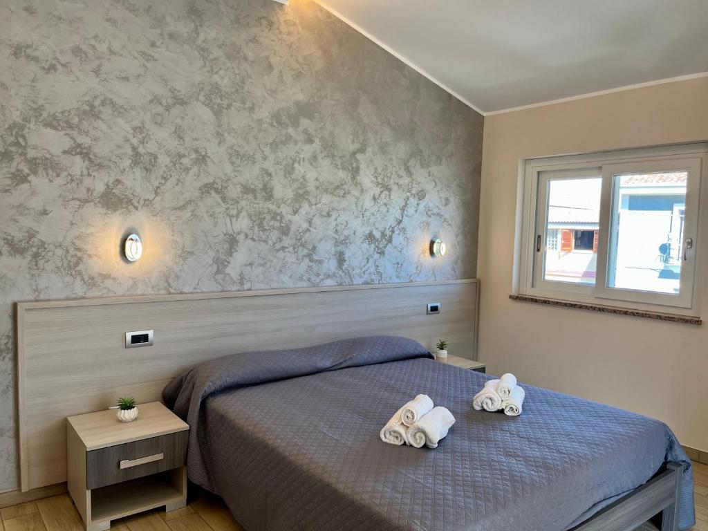 a bedroom with a bed with two towels on it at B&B Galatea in Santa Domenica
