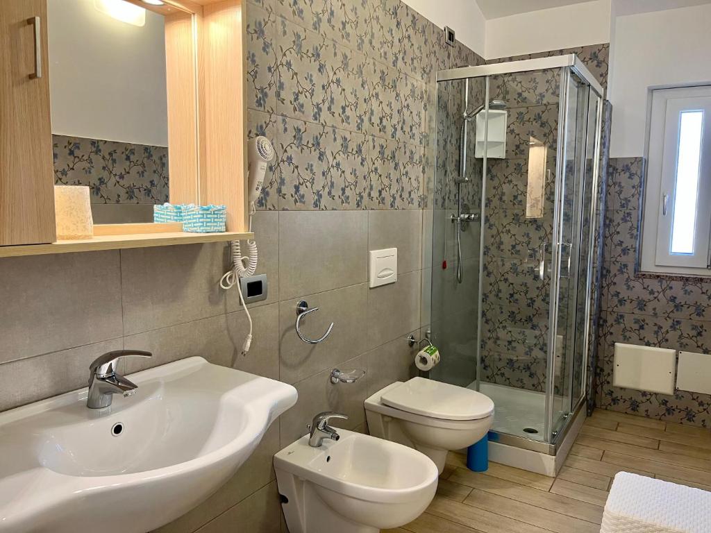 a bathroom with a sink and a toilet and a shower at B&B Galatea in Santa Domenica