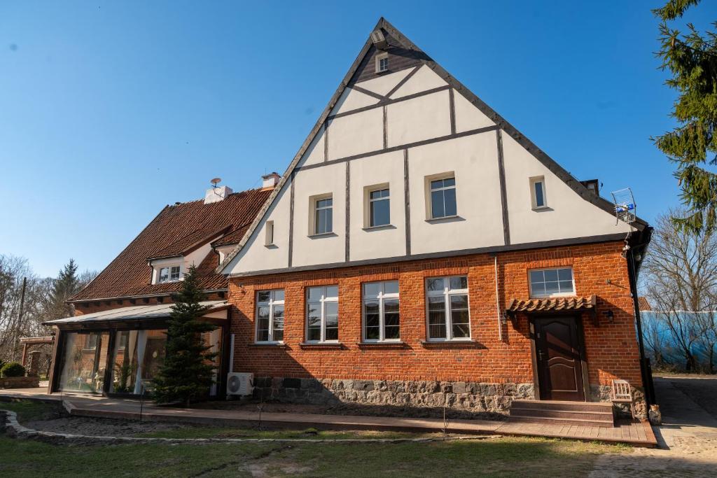an old house with a gambrel roof at Osada Mazurowe Love in Miłakowo
