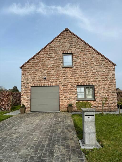 a large brick house with a garage at THE 11 gîte pour vacances ou travail in Comines