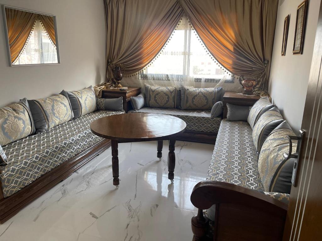a living room with a couch and a table at Nador Apartment in Nador