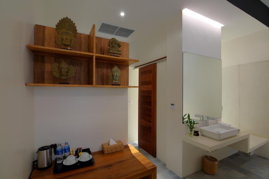 a bathroom with a sink and a toilet and a counter at Apsara Residence Hotel in Siem Reap