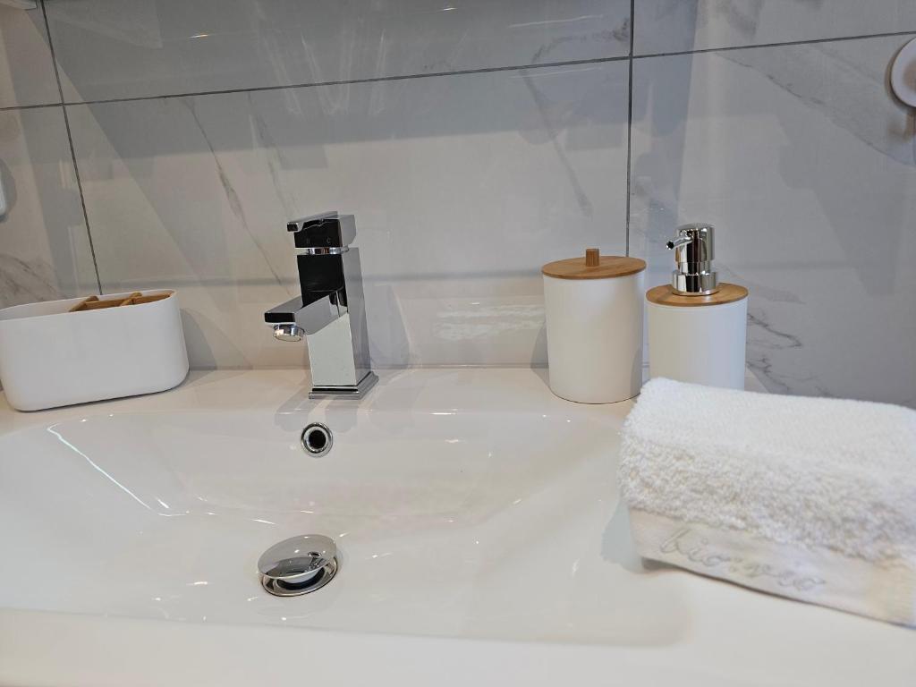 a white bathroom with a sink and two toilets at Appartment Jasmin in Liezen