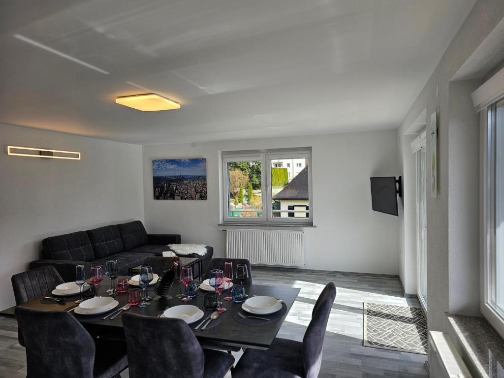 a dining room with a table and chairs and a couch at Appartment Jasmin in Liezen