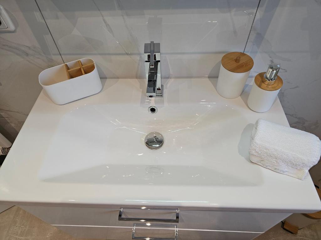 a white sink in a bathroom with two toilets at Appartment Jasmin in Liezen