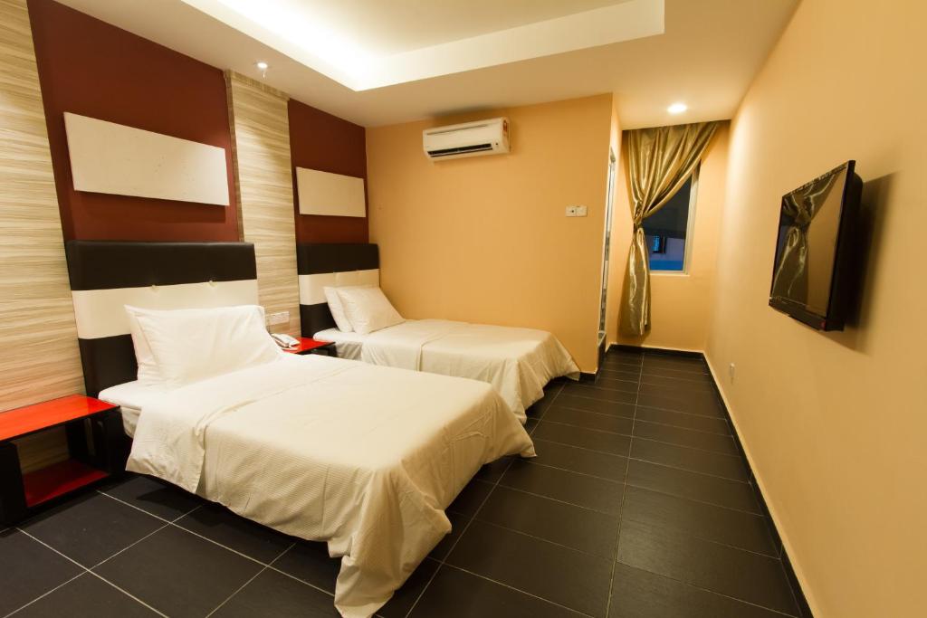 Postel nebo postele na pokoji v ubytování JS Hotel