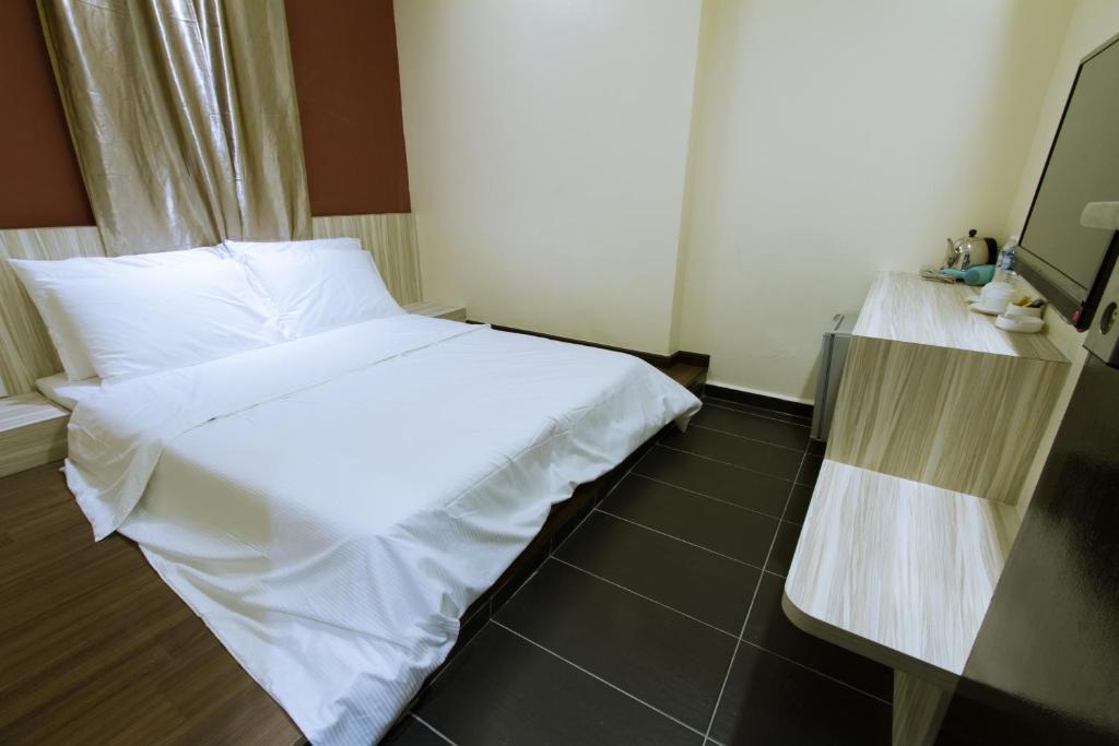 Postel nebo postele na pokoji v ubytování JS Hotel