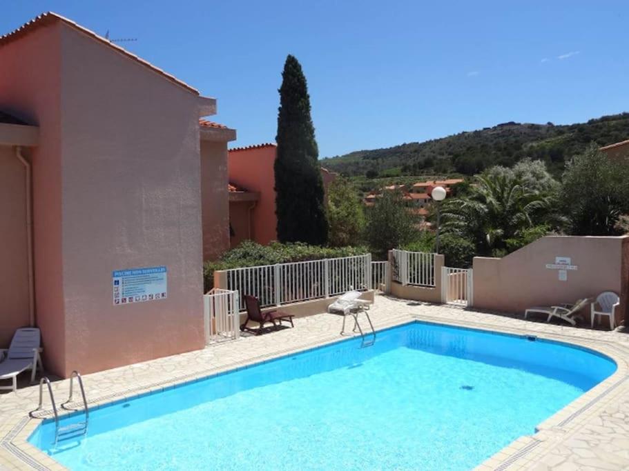 a large swimming pool in front of a house at Collioure, entre mer, piscine & montagne in Collioure