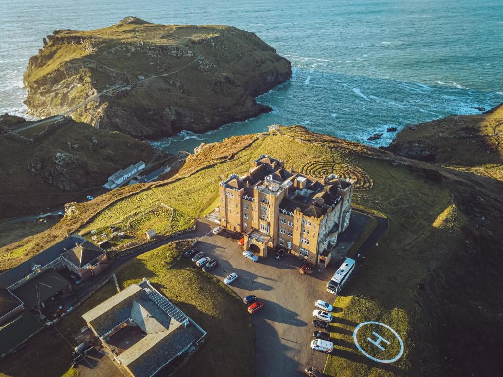 an aerial view of a train on a cliff near the ocean at Camelot Castle Hotel in Tintagel