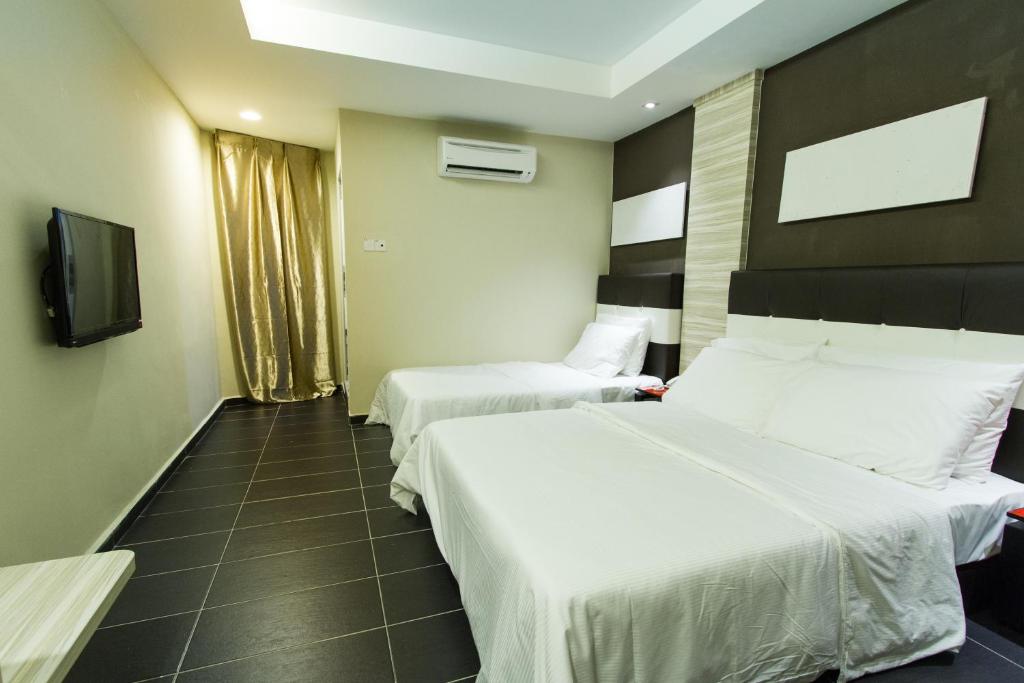 Postel nebo postele na pokoji v ubytování JS Hotel
